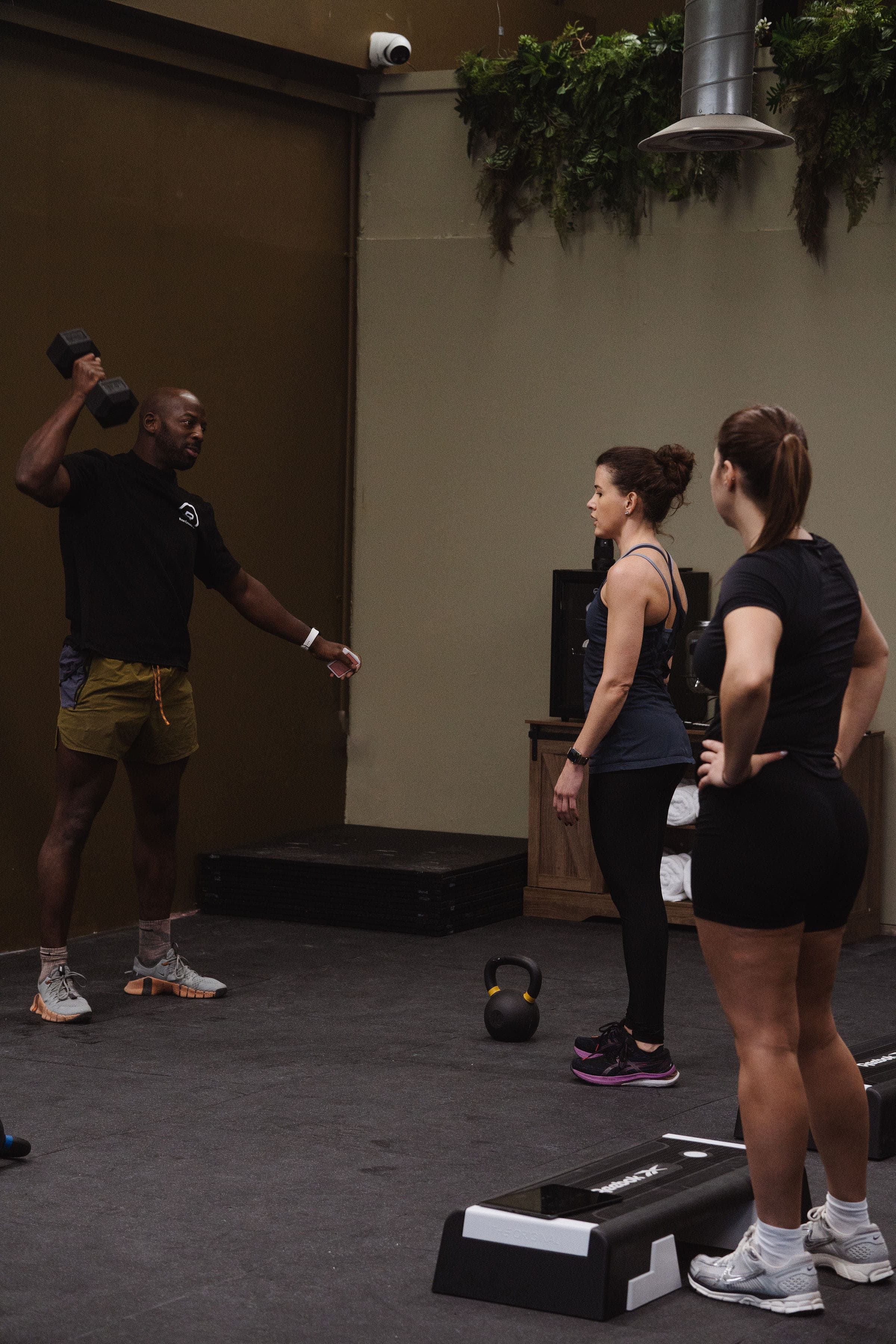 Rise Fitness gym interior with wooden slat walls and equipment